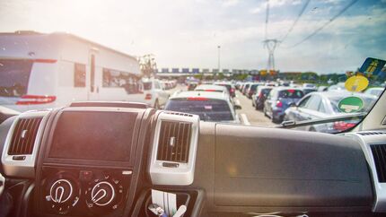 Queuing cars in holiday season as seen through campervan's window